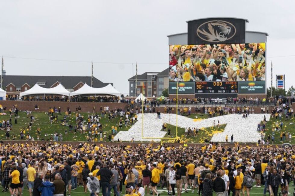 Fans rush the field after Missouri defeated Kansas State 30-27 in an NCAA college football...