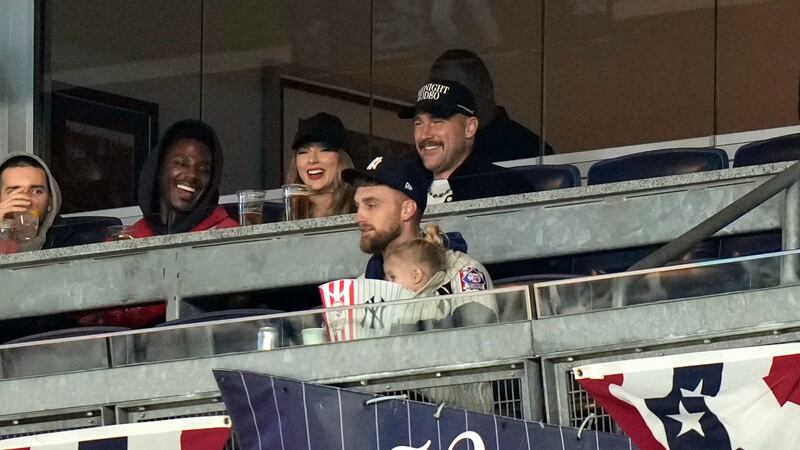 Travis Kelce, top right, and Taylor Swift watch Game 1 of the baseball AL Championship Series...