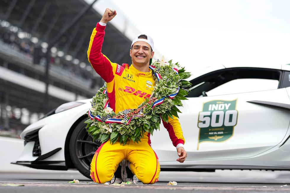Alex Palou, of Spain, celebrates on the Yard of Bricks on the start/finish line after winning...