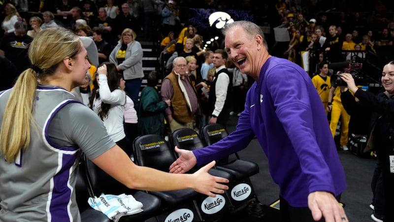 Kansas State head coach Jeff Mittie, right, celebrates with guard Taryn Sides, left, after an...