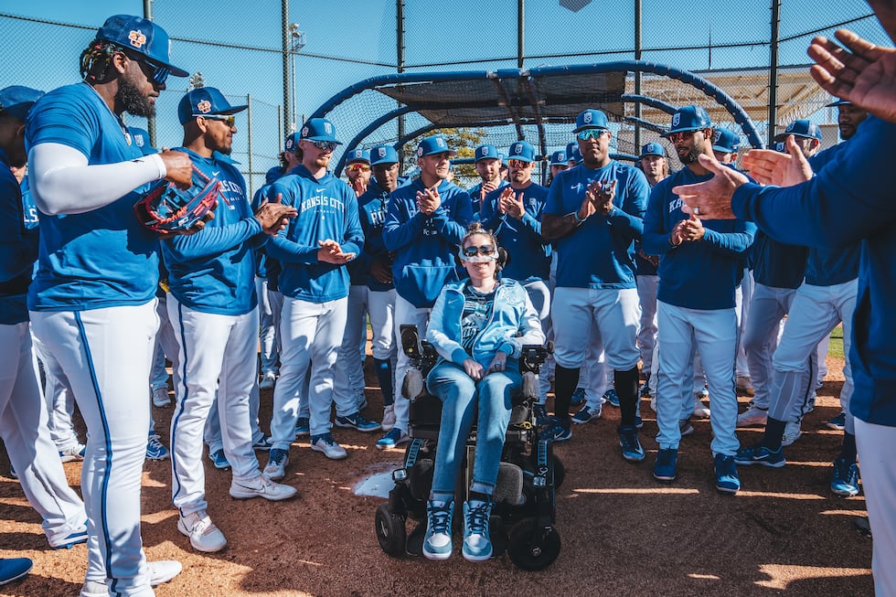 Sarah Na poses with the Kansas City Royals.