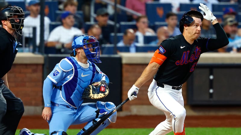 New York Mets' Jared Young grabs his helmet after hitting a pop fly ball for an out against...