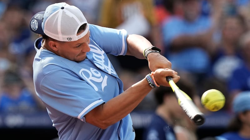 Kansas City Chiefs quarterback Patrick Mahomes bats during a softball game at Kauffman Stadium...