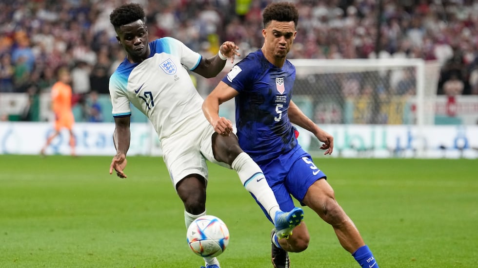 Antonee Robinson of the United States vies for the ball with England's Bukayo Saka, left,...