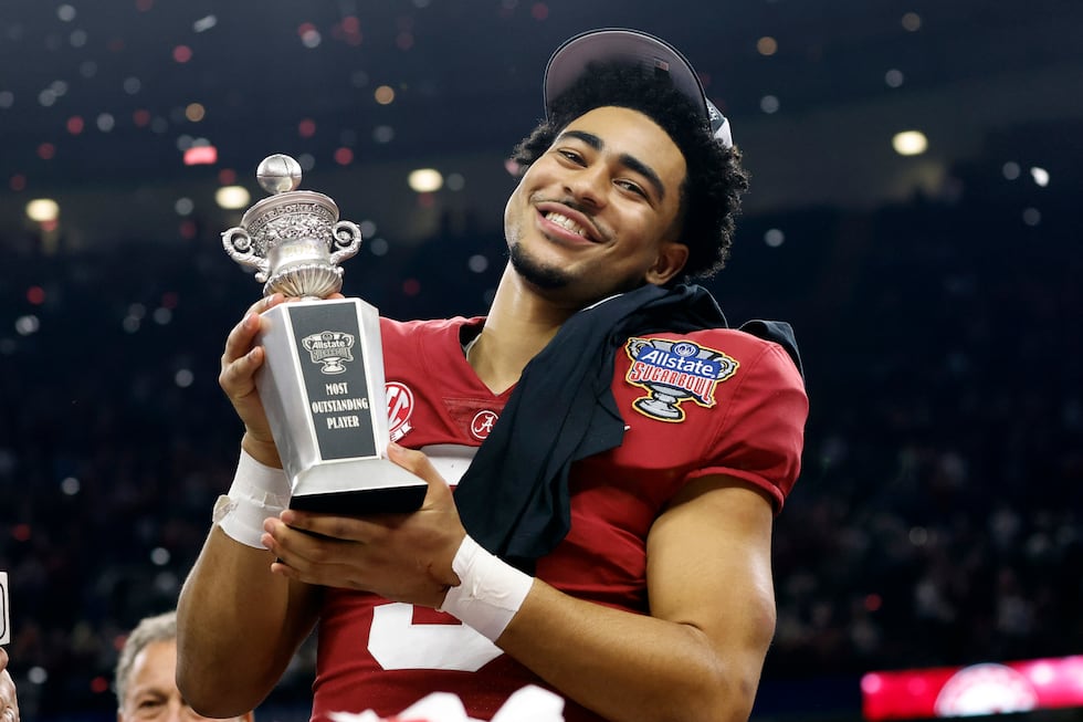FILE - Alabama quarterback Bryce Young holds the Most Outstanding Player trophy after Alabama...