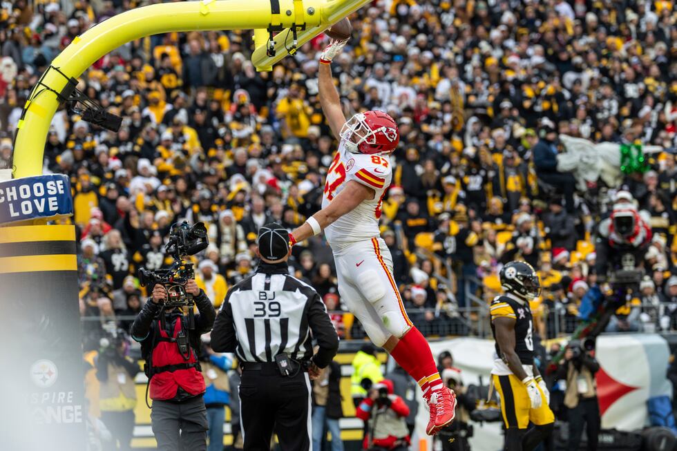 Kansas City Chiefs tight end Travis Kelce (87) dunks the football over the goal post after...