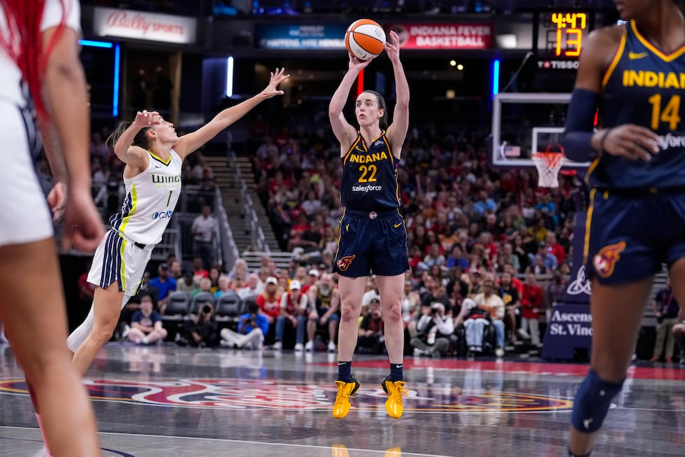Indiana Fever guard Caitlin Clark (22) shoots over Dallas Wings guard Sevgi Uzun (1) in the...