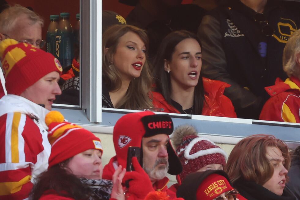 Taylor Swift watches from a suite with basketball player Caitlin Clark, right, during the...