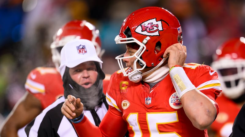 Kansas City Chiefs quarterback Patrick Mahomes heads to the bench to get his helmet replaced...