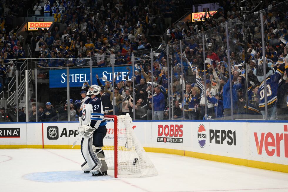 St. Louis Blues fans react as Winnipeg Jets goaltender Connor Hellebuyck (37) looks on during...