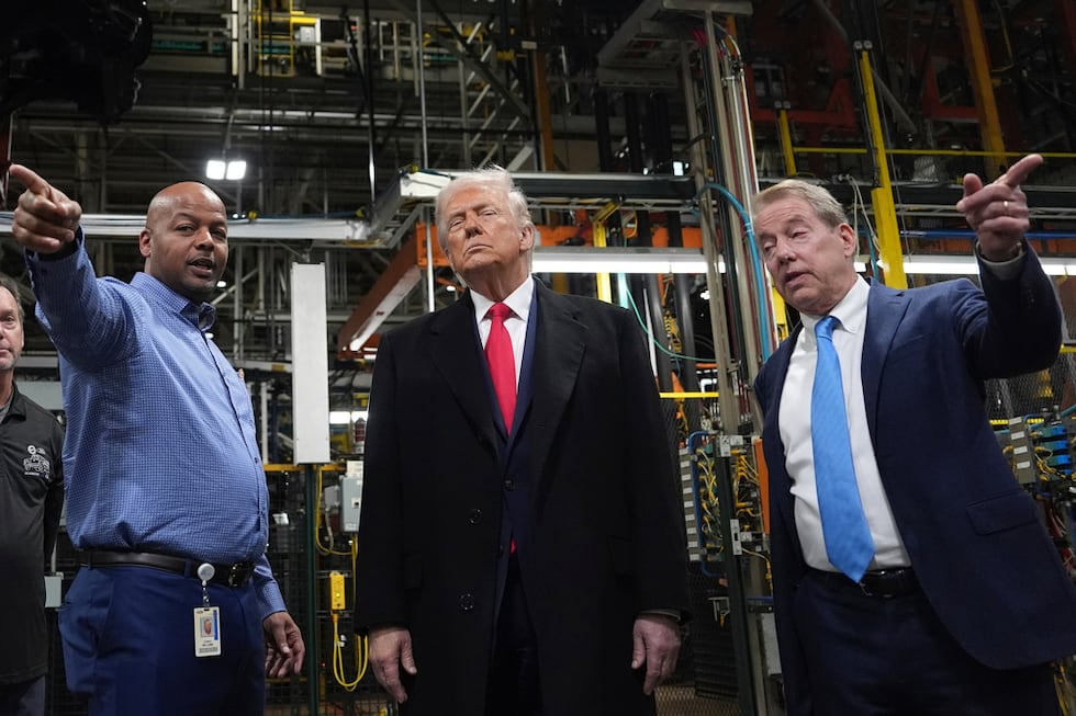 President Donald Trump listens to Corey Williams, Ford River Rouge Plant Manager, left, and...