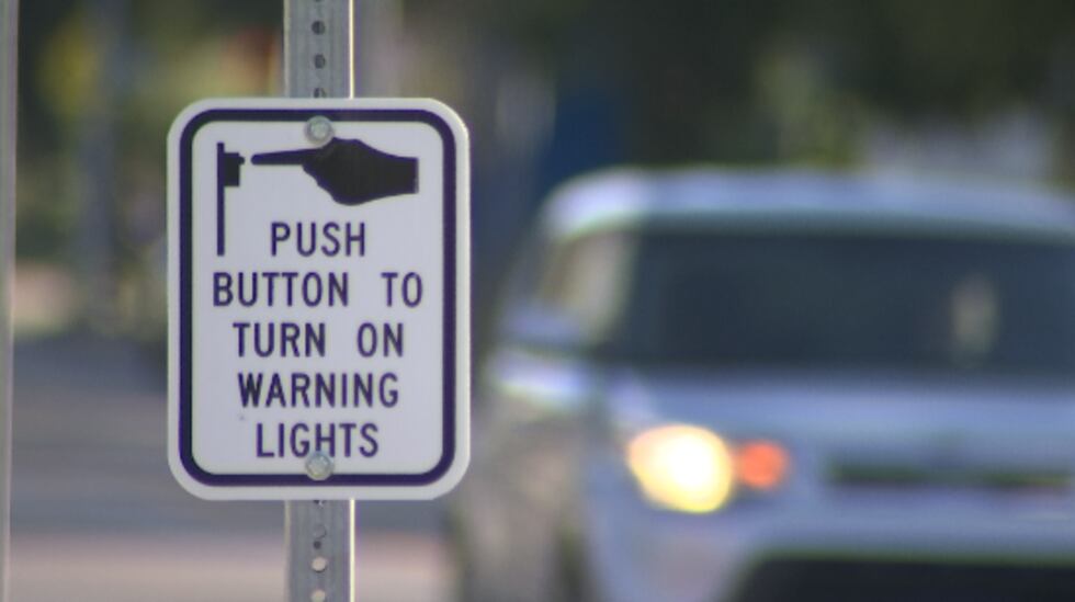 Instead of a stoplight, the city installed a crosswalk with signs that light up when...