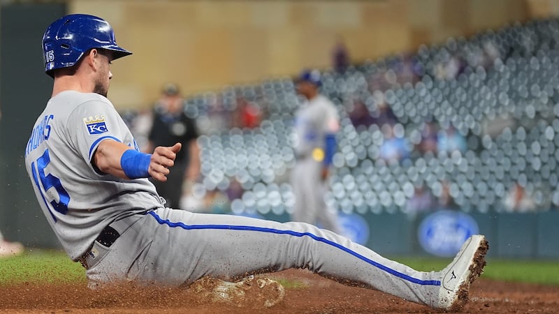 Kansas City Royals' Lane Thomas (15) slides to score off a two-run single hit by Josh Rojas...