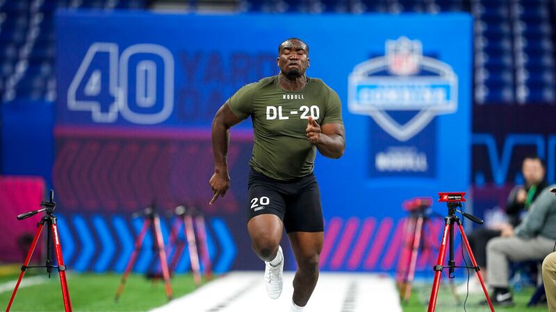 FILE: Northwestern defensive lineman Adetomiwa Adebawore runs a drill at the NFL football...