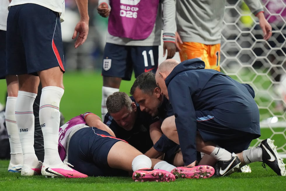 England's Jordan Henderson (14) is looked after by training staff following an injury in the...