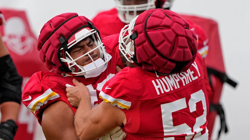 Kansas City Chiefs center Creed Humphrey (52) and offensive tackle Kingsley Suamataia (76)...