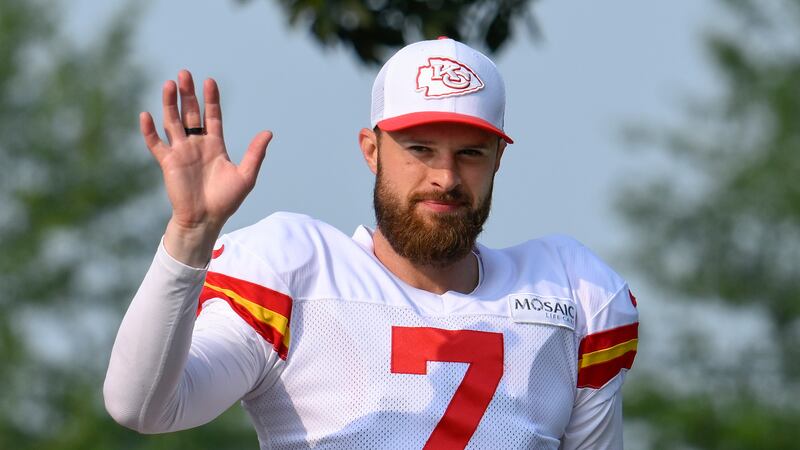 Kansas City Chiefs kicker Harrison Butker waves to the fans as he walks to the field at the...