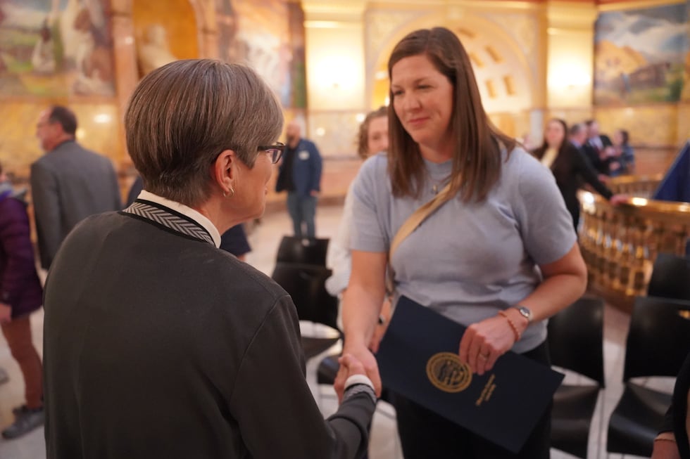 Governor Laura Kelly signs the state's new bell-to-bell cellphone ban into law on March 19, 2026.