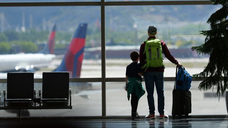 FILE - Travelers pass through Salt Lake City International Airport on May 24, 2024, in Salt...