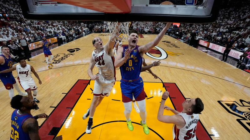 Denver Nuggets guard Christian Braun (0) drives to the basket as Miami Heat center Cody Zeller...