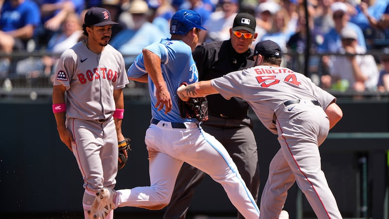 Kansas City Royals' Luke Maile (15) is tagged out by Boston Red Sox starting pitcher Lucas...
