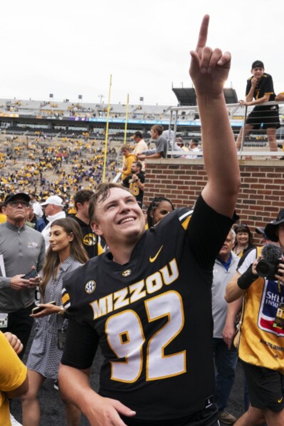 Missouri kicker Harrison Mevis points to fans as he walks off the field after defeating Kansas...