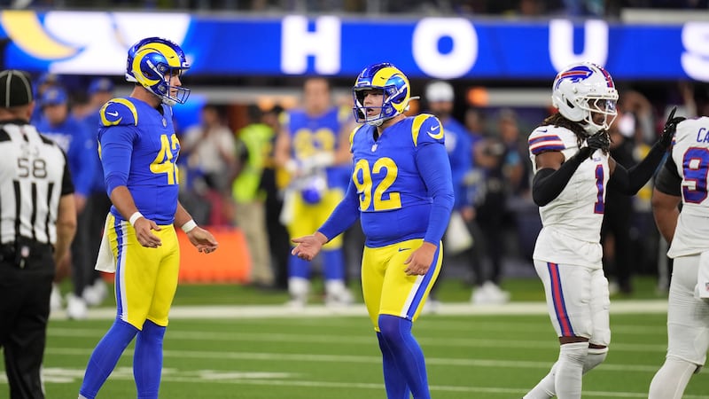 Los Angeles Rams place kicker Harrison Mevis, center, and punter Ethan Evans, left, react...