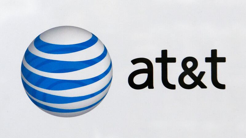 In this photo taken Thursday, Feb. 5, 2015 the At&T logo on display at a local store in...