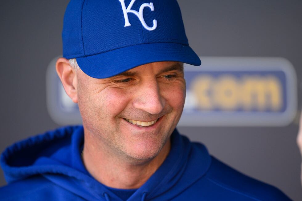 Kansas City Royals manager Matt Quatraro (33) chats in the dugout during warmups before their...