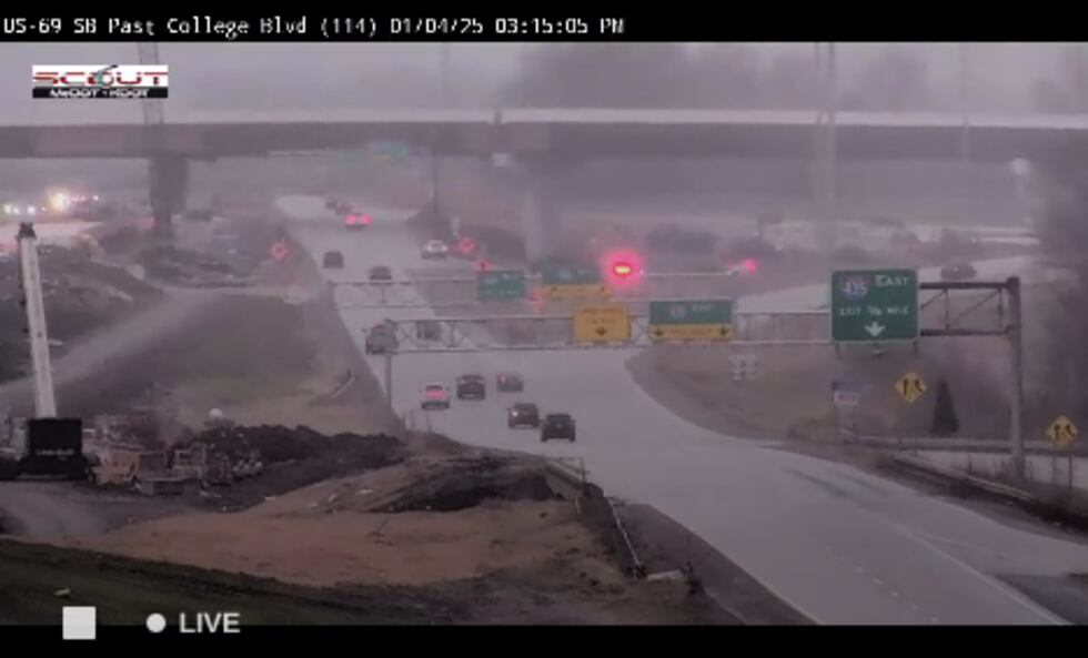 Crews clear the scene of a crash at U.S. 69 at College Blvd. as winter weather moves in on...