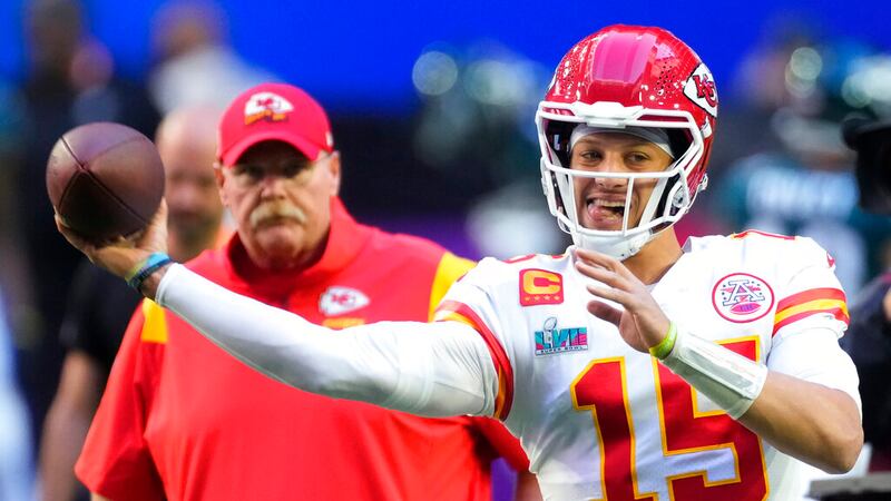 FILE: Kansas City Chiefs quarterback Patrick Mahomes (15) warms up as head coach Andy Reid...