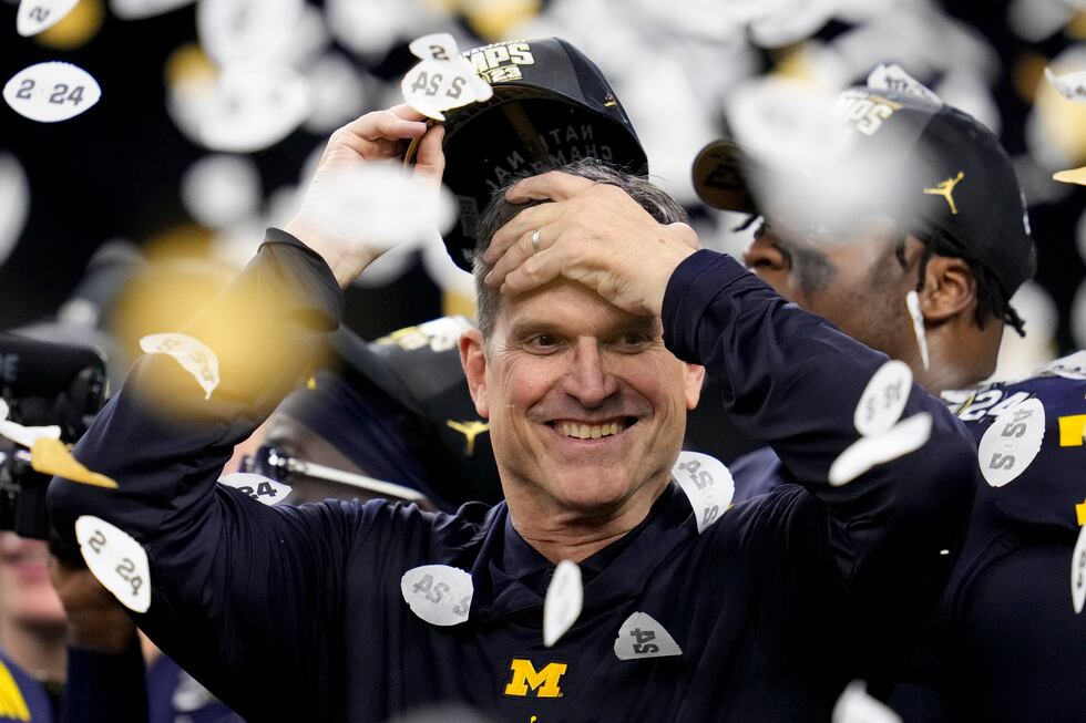 FILE - Michigan coach Jim Harbaugh celebrates the team's win in the national championship NCAA...