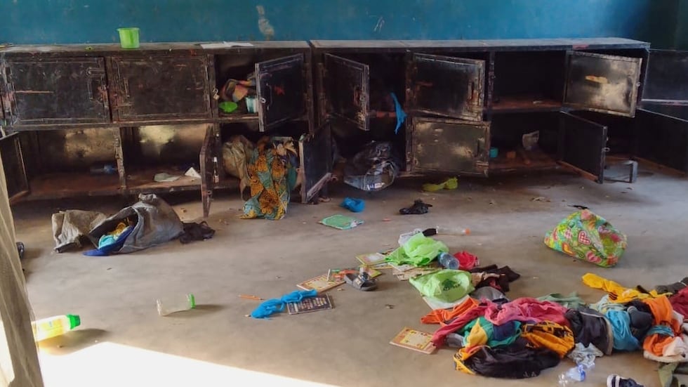 In this photo released by Christian Association of Nigeria, a man walk past belongings at the...