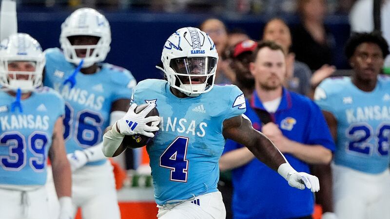 Kansas running back Devin Neal (4) runs for a first down during the first half of an NCAA...