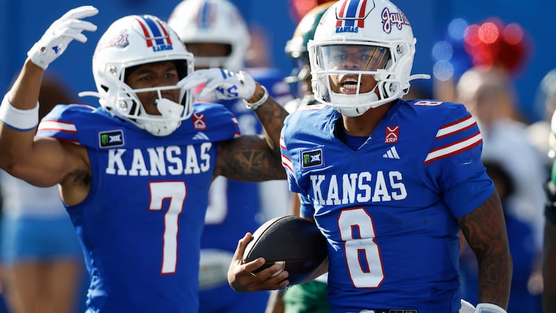 Kansas quarterback Isaiah Marshall (8) celebrates his rushing touchdown with wide receiver Cam...
