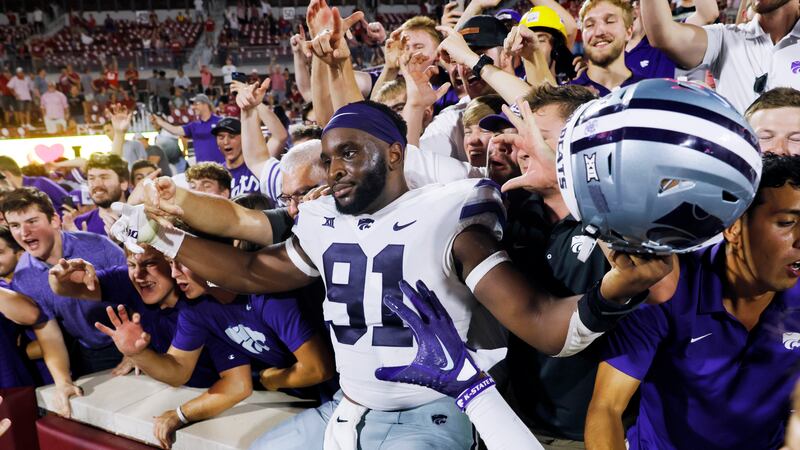 FILE: Kansas State defensive end Felix Anudike-Uzomah celebrates with fans after an NCAA...