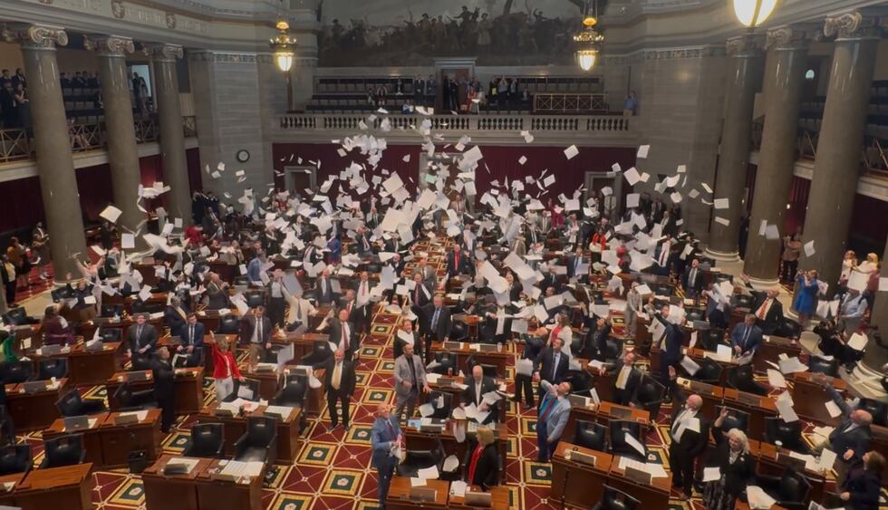 Discarded papers rained down on the representatives in the Missouri House Chamber who cheered...