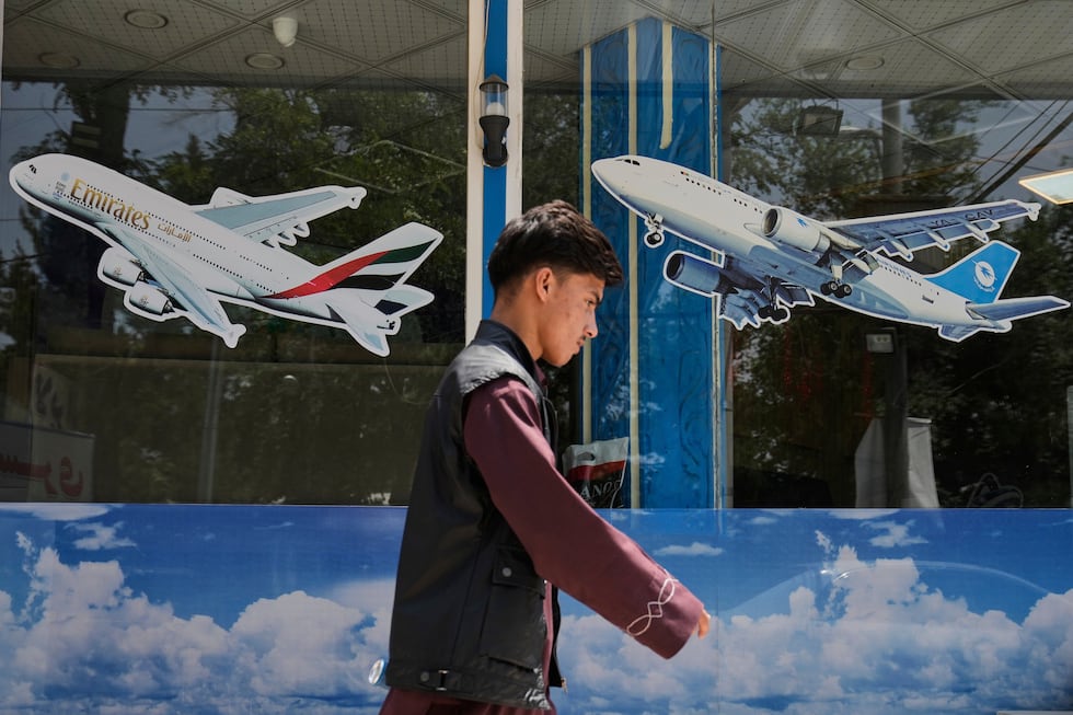 An Afghan man es in front of an air travel agency in Kabul, Afghanistan, Thursday, June 5,...