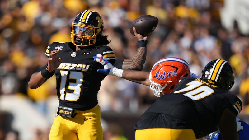 Missouri quarterback Austin Simmons (13) throws during the first half of an NCAA college...