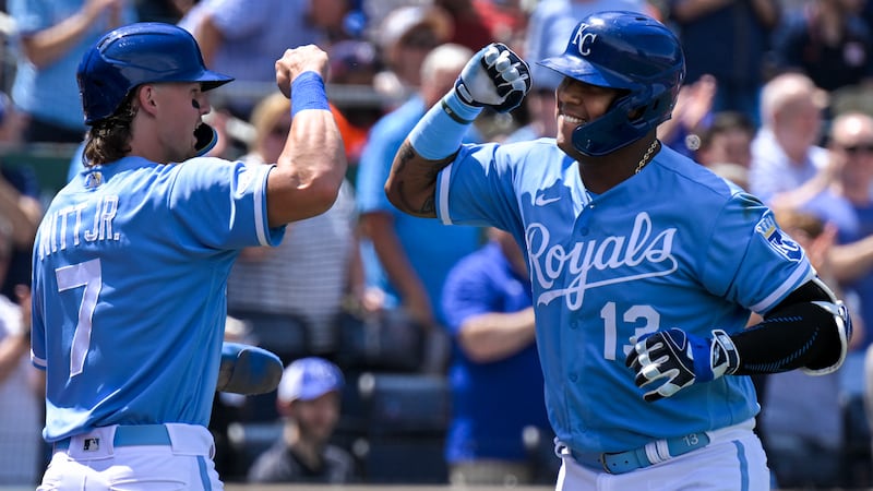 The Kansas City Royals' Salvador Perez (13) celebrates his two-run home run with teammate...