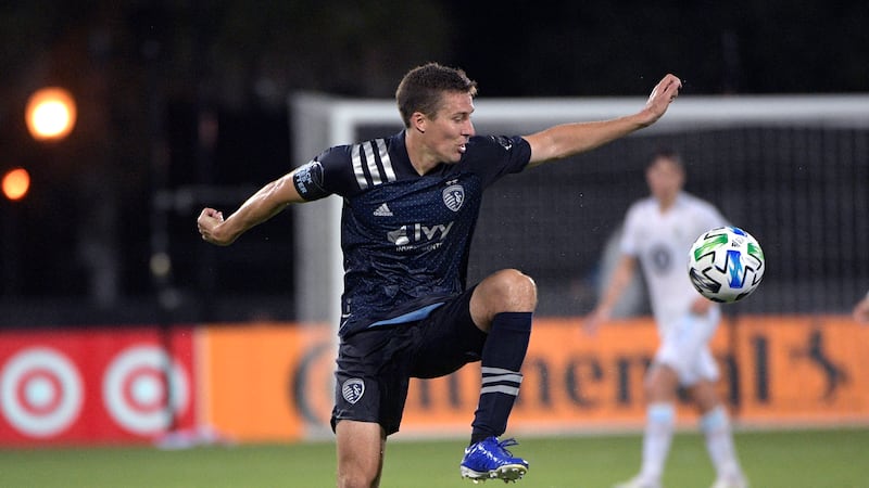 Sporting Kansas City defender Matt Besler, left, controls a during the first half of an...