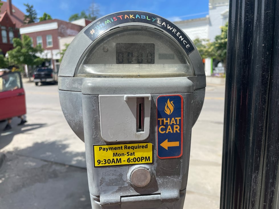 The city of Lawrence is implementing a new parking policy giving drivers with unpaid parking...