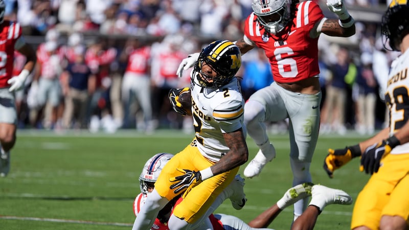 Missouri wide receiver Caleb Goodie Sr. (2) is pursued by Mississippi safety Joenel Aguero (6)...