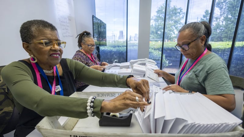 FILE - From left, Carol Hamilton, Cristo Carter and Cynthia Huntley prepare ballots to be...
