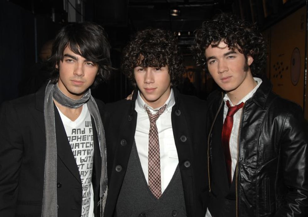 Singers Joe Jonas, left, Kevin Jonas and Nick Jonas, right, of the music group The Jonas...