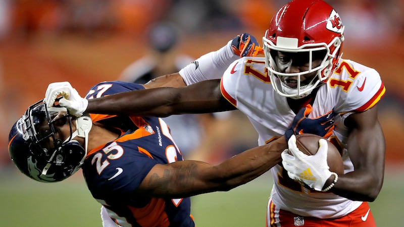Kansas City Chiefs wide receiver Chris Conley (17) stiff arms Denver Broncos defensive back...