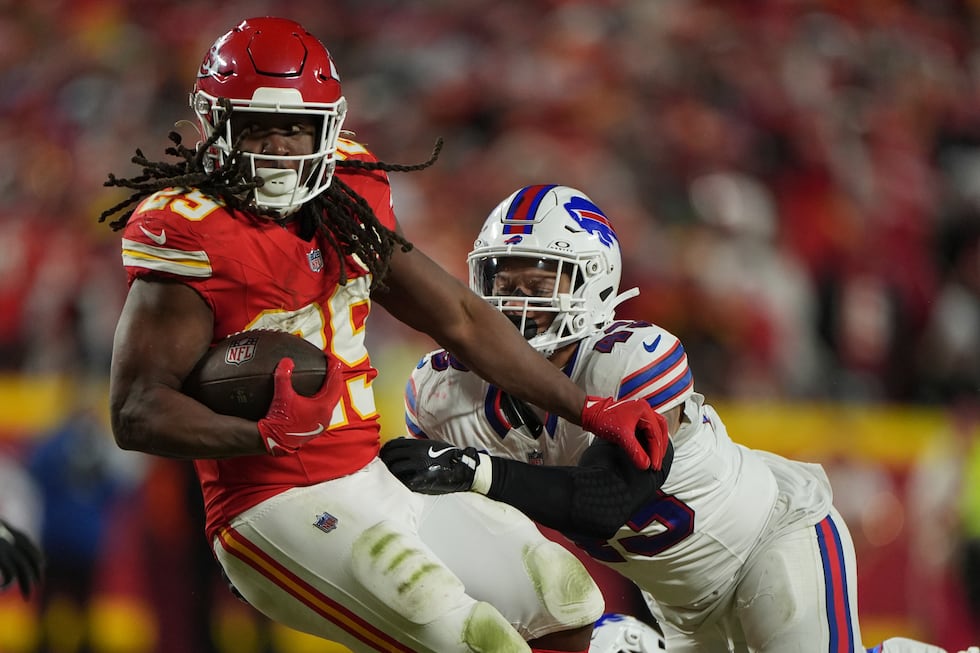 Kansas City Chiefs running back Kareem Hunt, left, gains against Buffalo Bills linebacker...