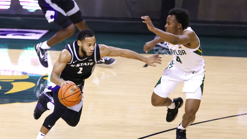 Kansas State guard Markquis Nowell (1) drives to the basket against Baylor guard LJ Cryer (4)...