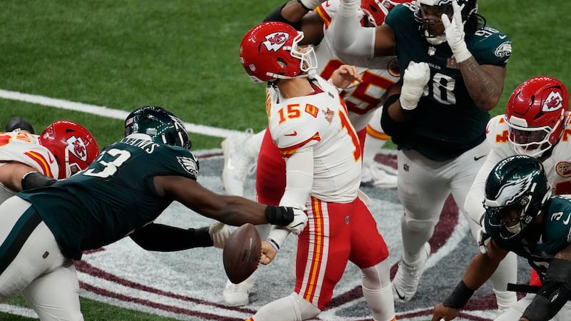 Philadelphia Eagles defensive tackle Milton Williams, left, strips the ball from Kansas City...