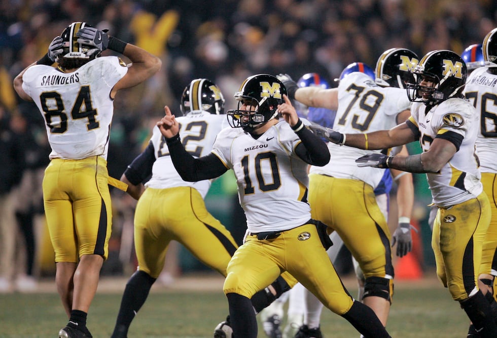 Missouri quarterback Chase Daniel celebrates with his teammates their victory over Kansas in...